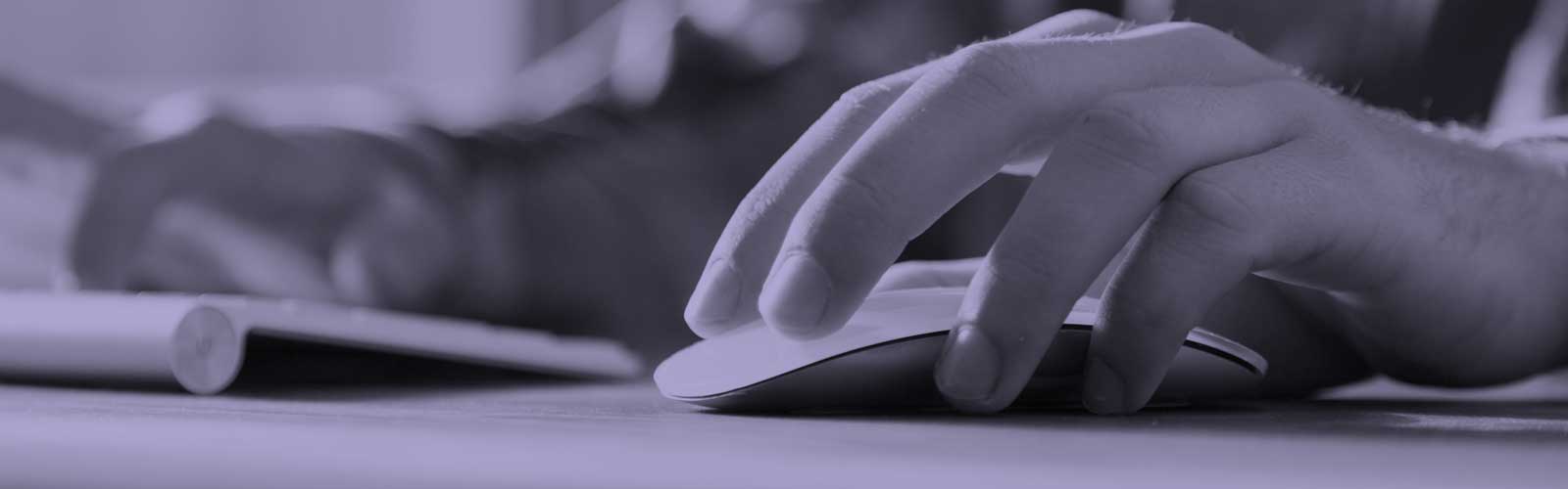 A close up of someone's hand using a computer mouse