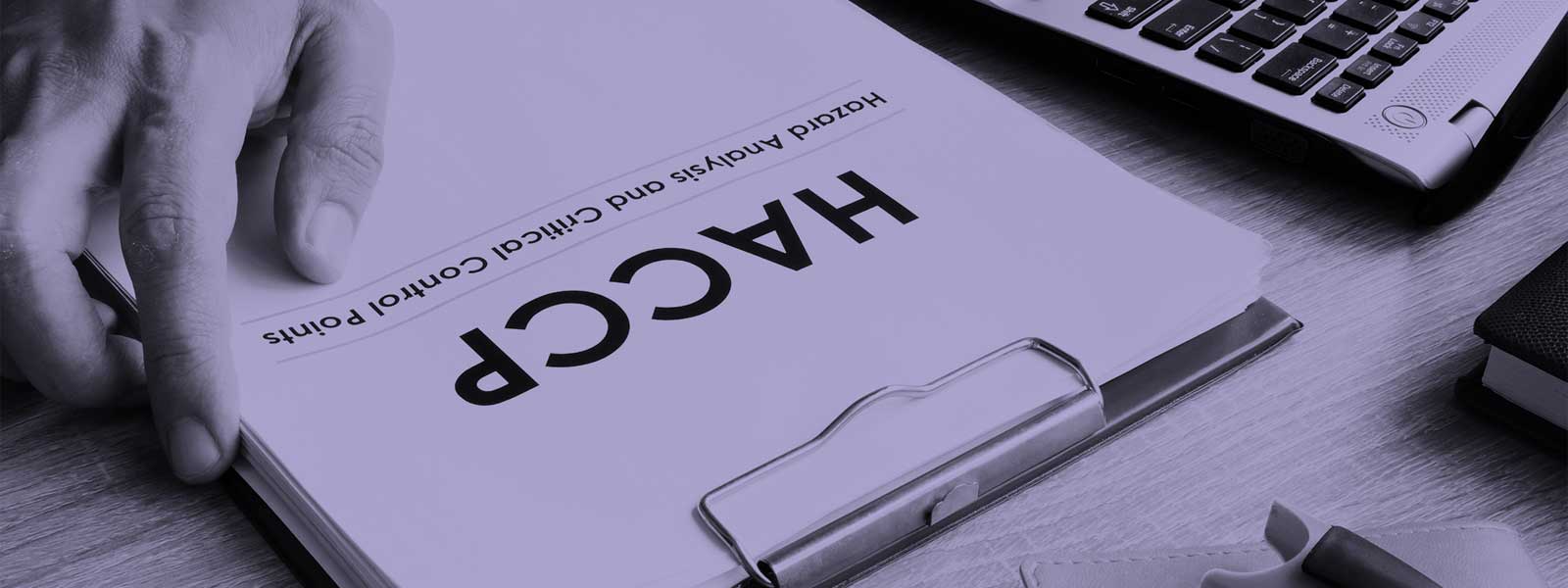 HACCP training documents in a clipboard
