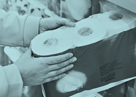 Hand taking toilet roll from a shelf