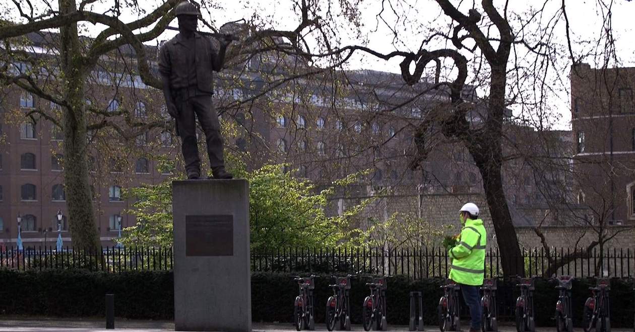 A protester at the 'Unknown building worker' statue in London