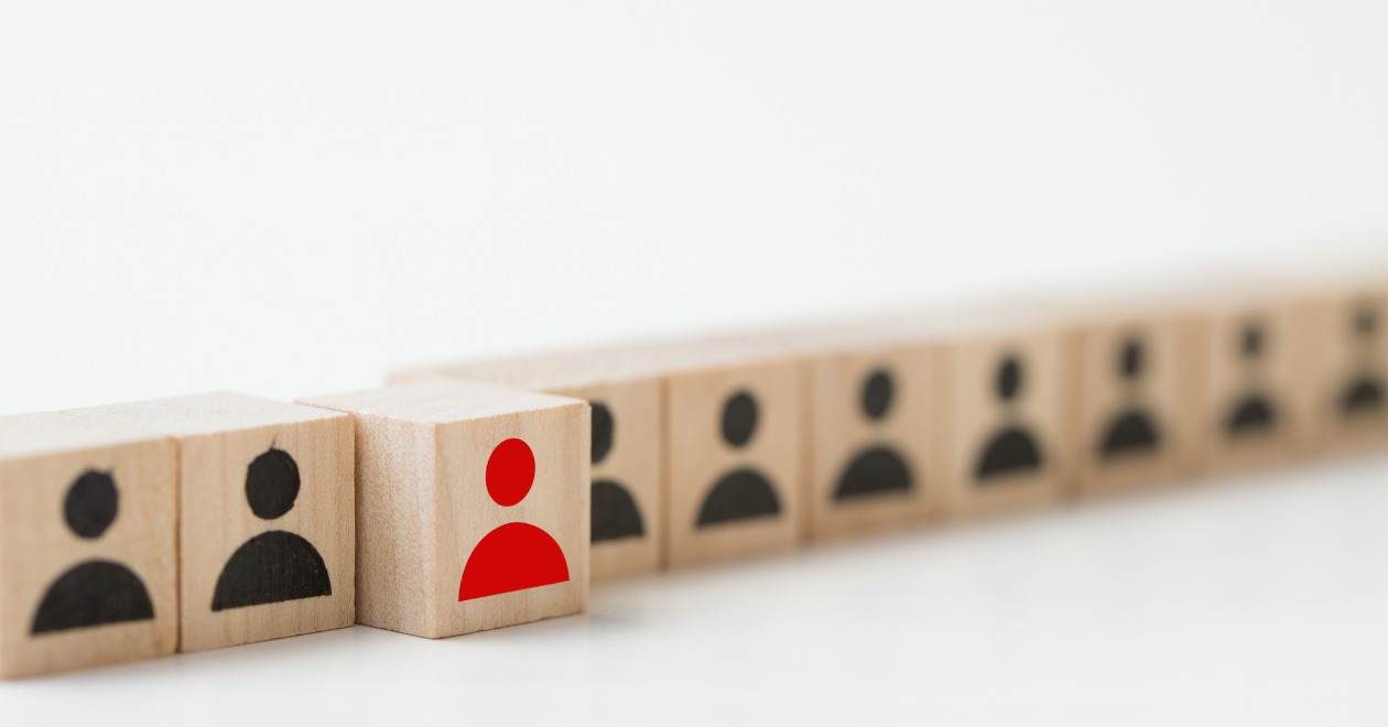 Wooden block with people symbols on