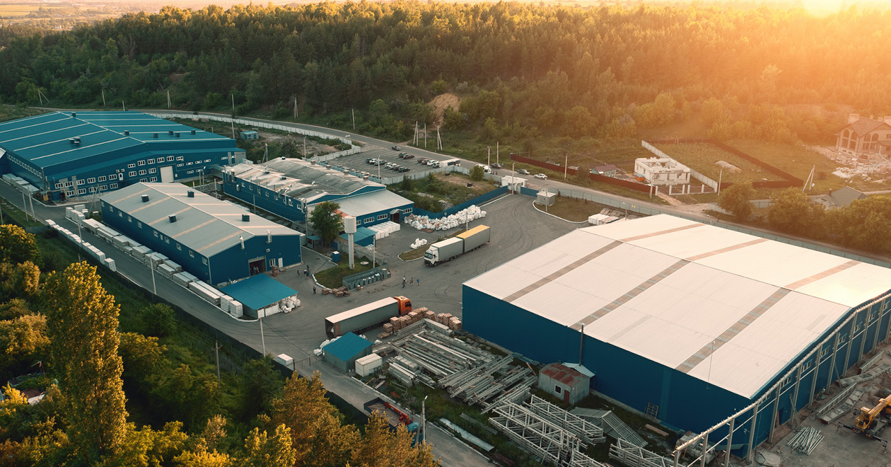 Industrial warehouses surrounded by trees