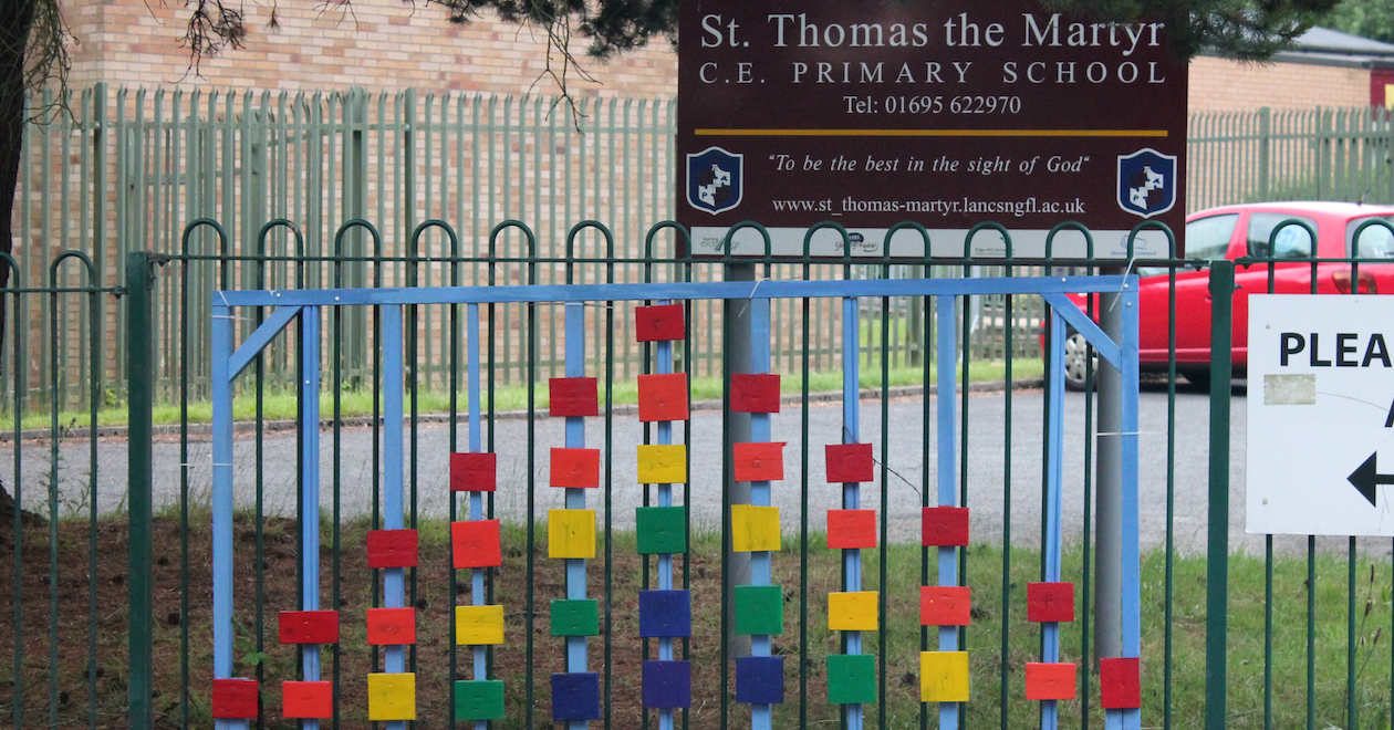 Up Holland, West Lancashire, UK: wooden rainbow blocks on a school gate in support of the NHS