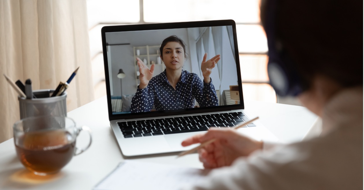Man watching webinar on laptop