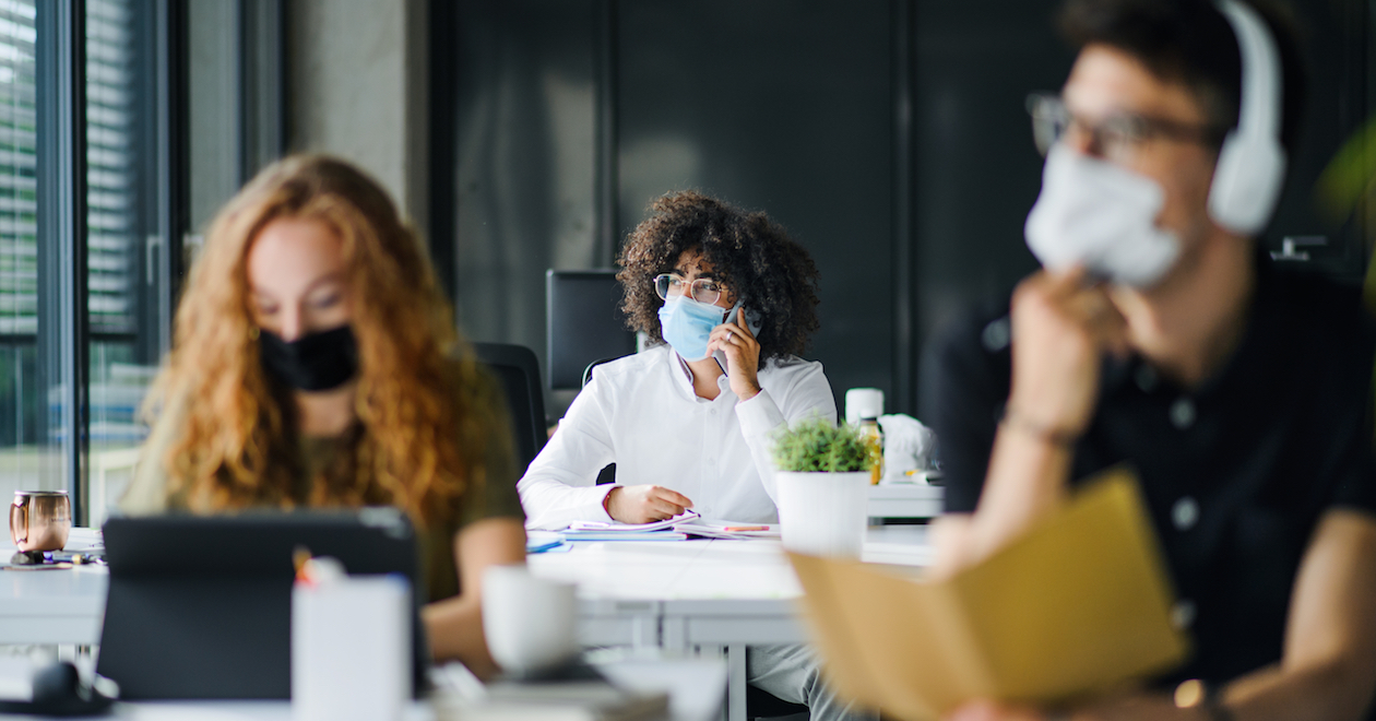 People in an office wearing masks