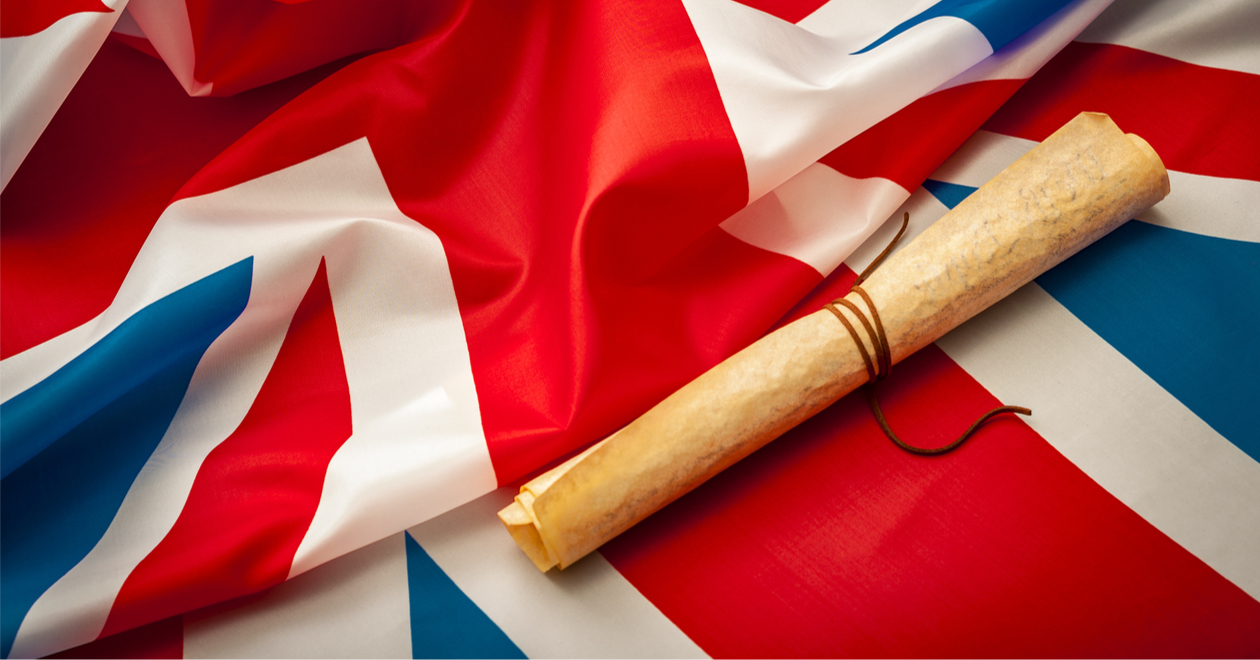 Rolled-up scroll representing Magna Carta on top of a rumpled Union flag