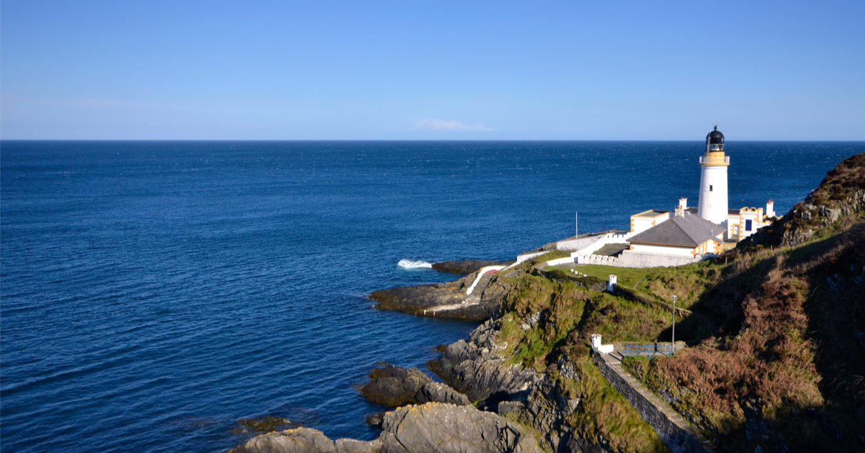 Douglas Lighthouse on the Isle of Man with sea on sunny day