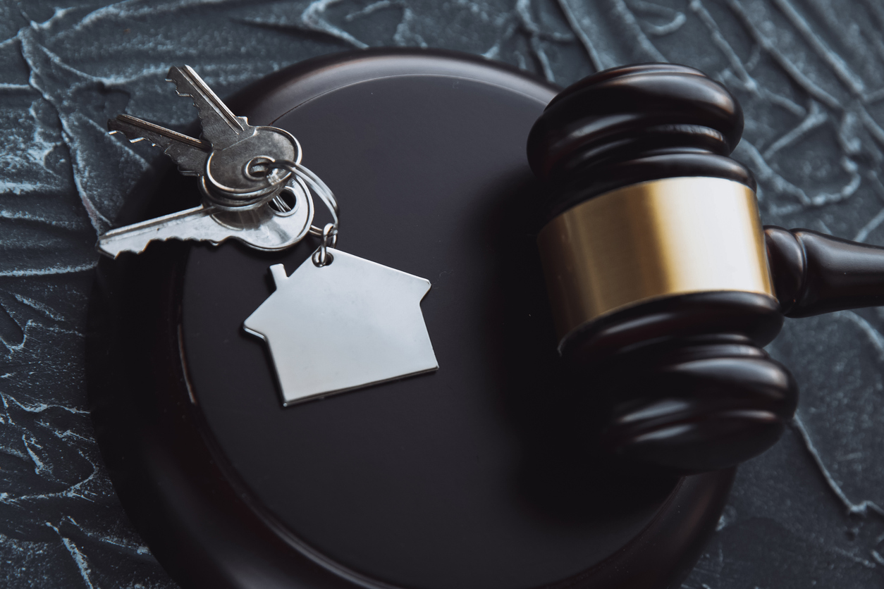 Gavel wooden and a set of keys with a house tag