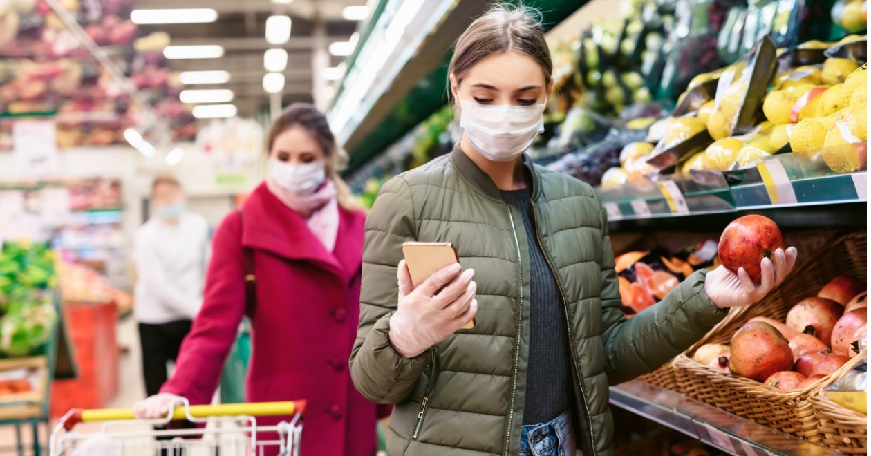 Woman holding apple in supermarket