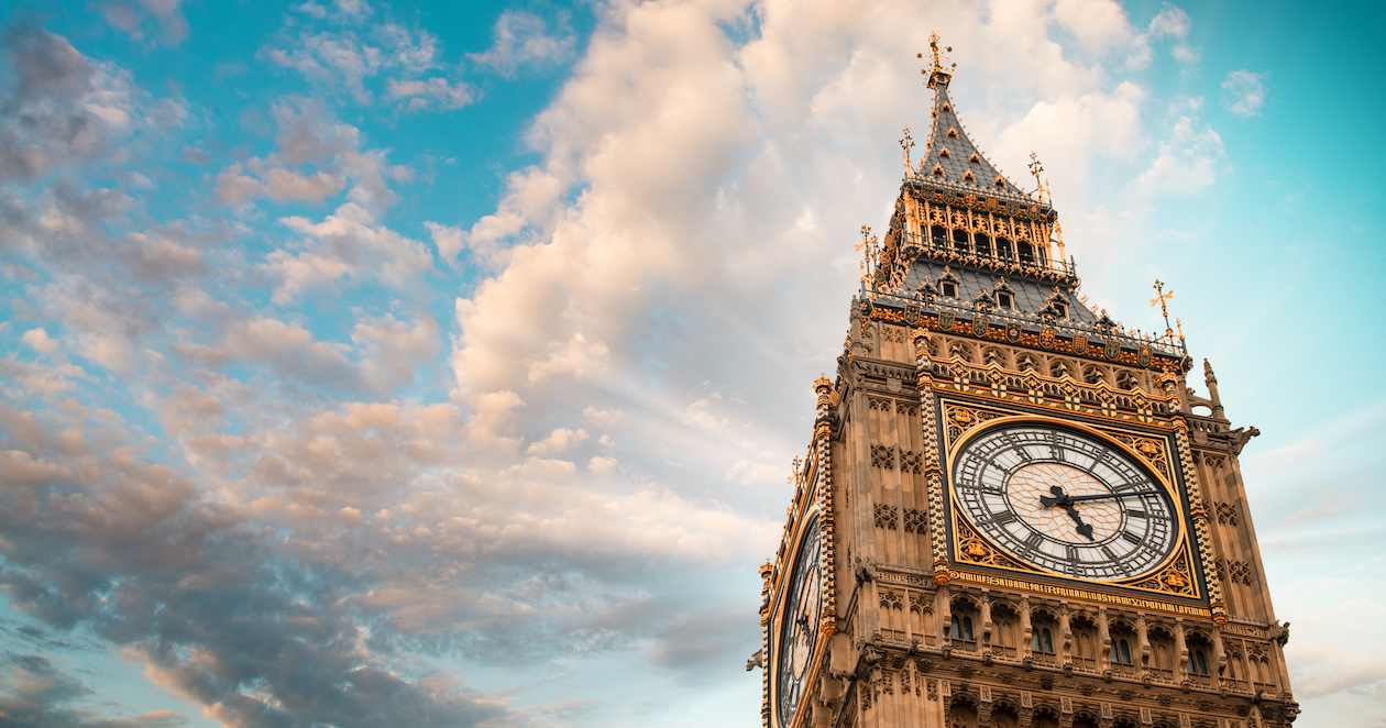 Big Ben clock tower against a blue sky with clouds.