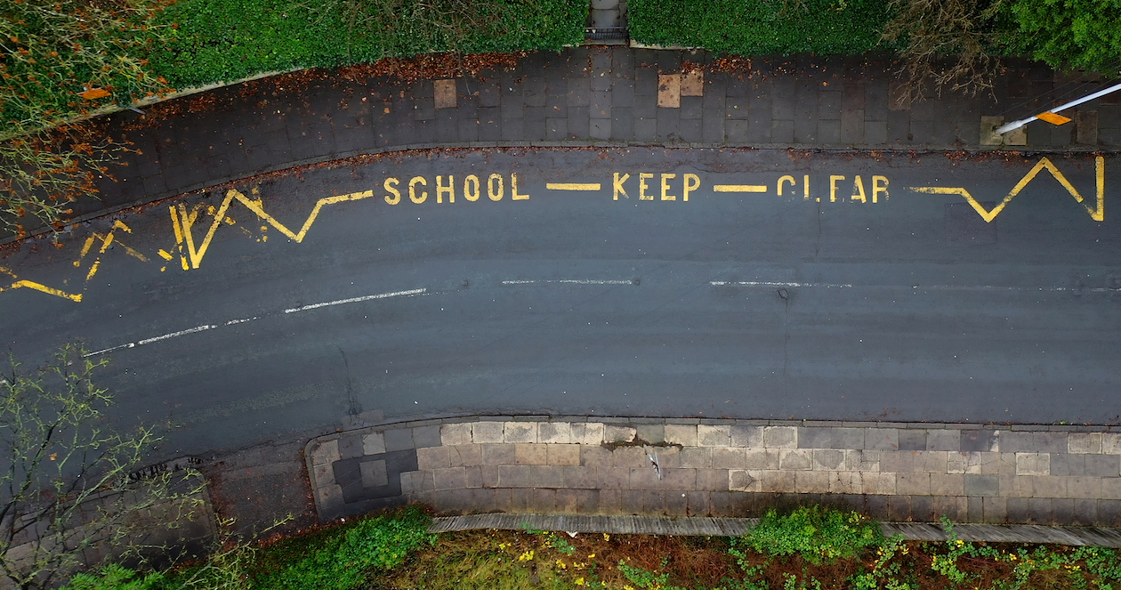 Aerial view of road markings saying 'school keep clear' 