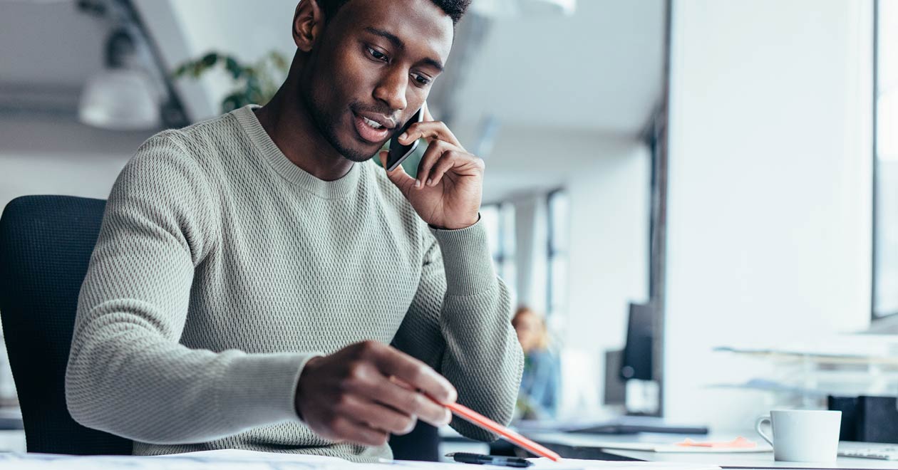 Man talking on a mobile phone in an office