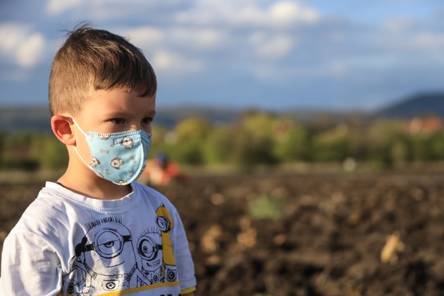 Young child with face mask on