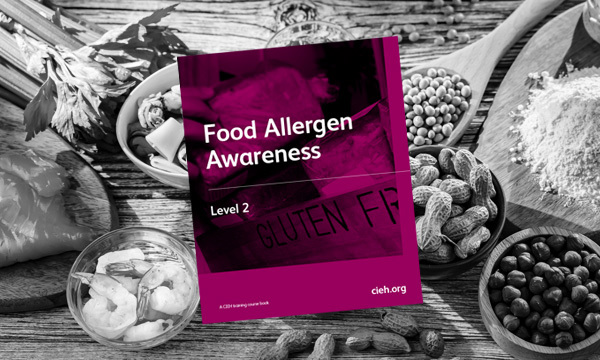 Gloved hands picking up biscuits