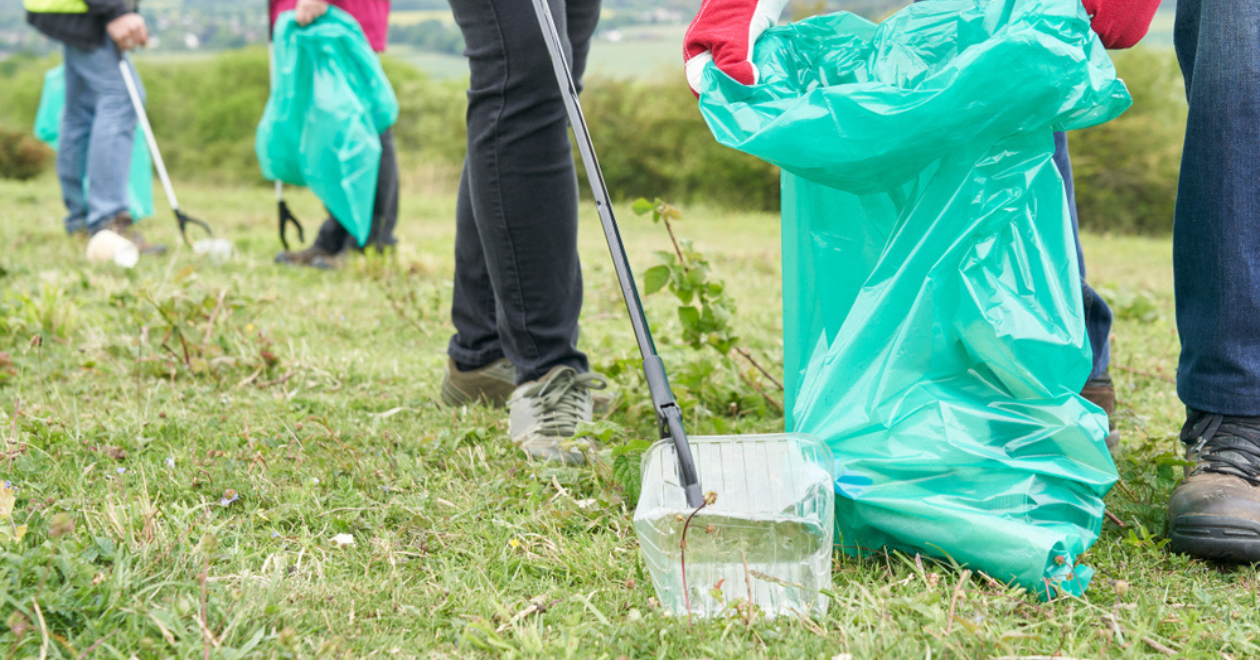 People gathering litter in a park